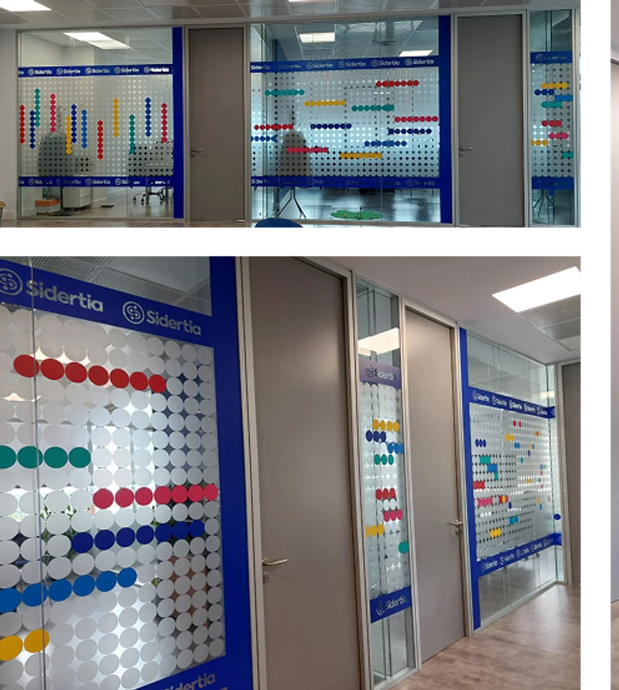 Glass offices with coloured dot patterns between blue brand bands